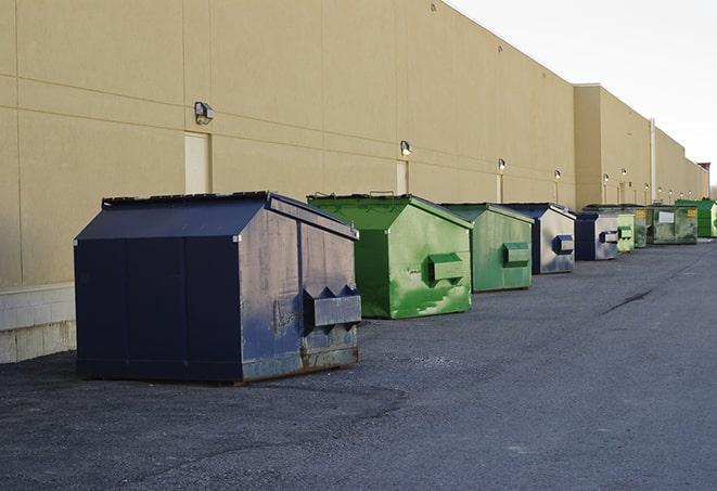 a row of large construction dumpsters on-site in East Lansing, MI